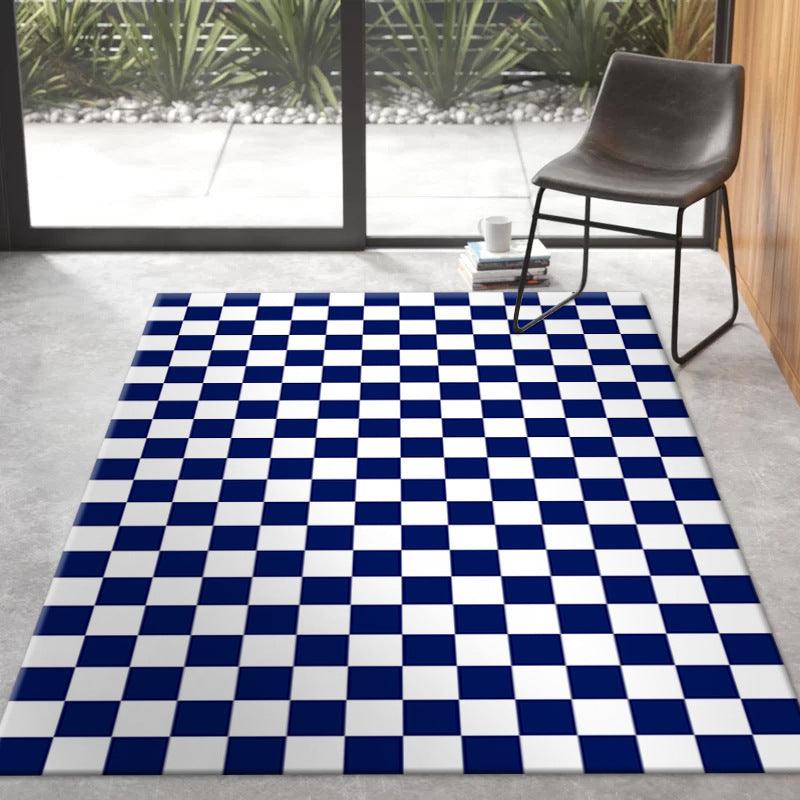Blue and white checkerboard rug beside a black chair