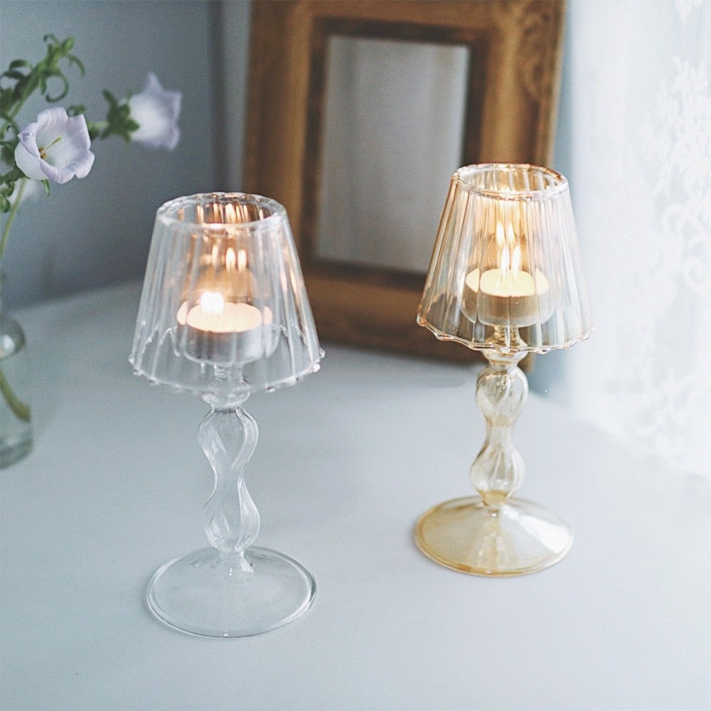 Glass tea-light holders with visible candle flames